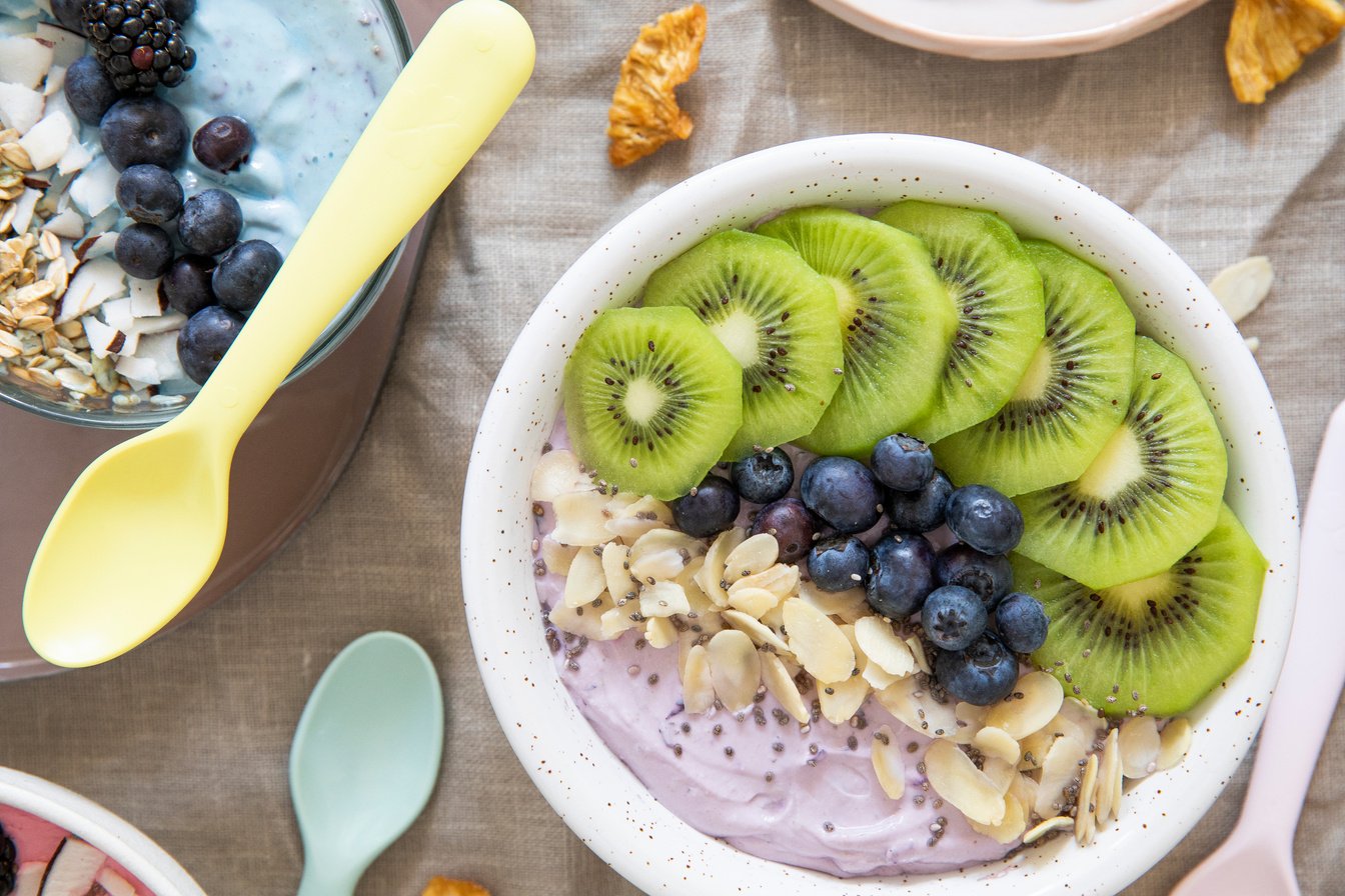 Smoothie Bowl with Kiwi, Blueberries, and Nuts Flatlay